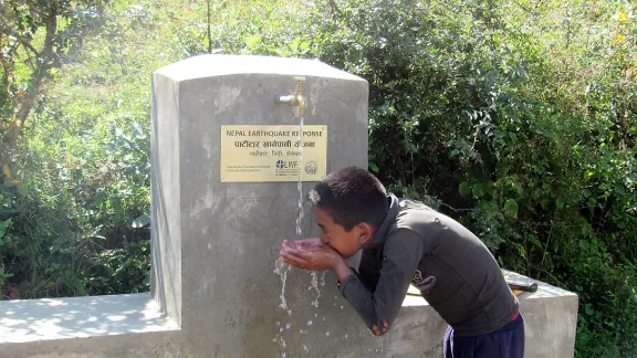 A child quenches his thirst from a water tap installed by LWF and HURADEC in Pattitar, Nepal. Photo: LWF/ M. Timsina