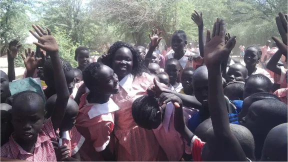 Margaret Awak Aguer is mobbed and lifted by fellow students at Shambe Primary School after emerging as the best candidate in Kakuma Refugee camp in the 2015 KCPE with 400 out of a possible 500 marks Â© LWF Kakuma January 2016