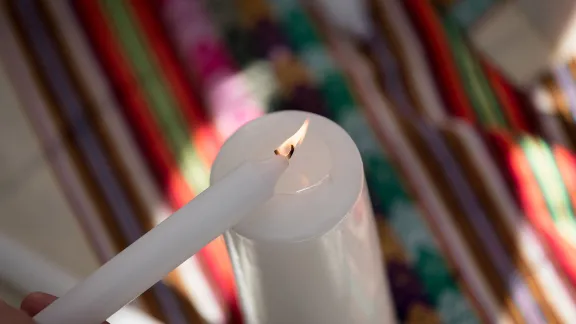 Lighting a candle during a âPrayer for the Rainforestâ as part of the Cumbre Social por el Clima, during COP25 that took place in Madrid, Spain, in 2019. Photo: LWF/Albin Hillert