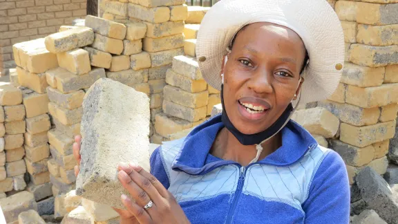 Bricklayer Makhatutu Siimane, showing what she can do with bricks. Photo: Outreach Foundation