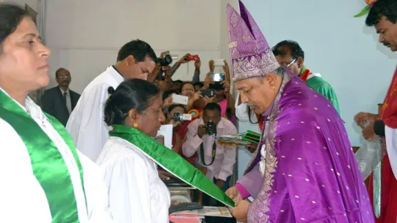 Bishop Emmanuel Panchoo declares Rev. Elizabeth Prasad an ordained pastor of the Madhya Pradesh Lutheran church, one of the first women to be ordained in the church. In the foreground, Rev. L.K. Khakha, another of the four women to be ordained by the church for the first time. Photo: ELC-MP/Nima David