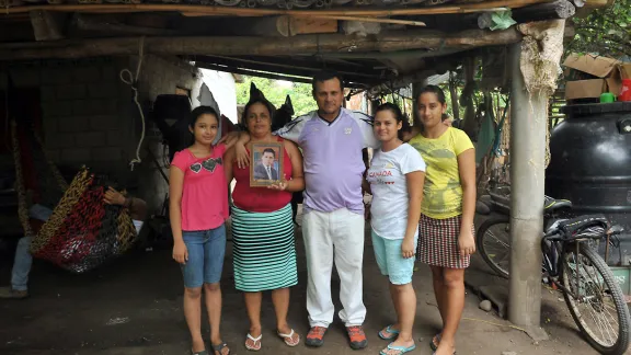 Rigoberto and his family with an image of their son, who was kidnapped on the migration route to the US. Photo: LWF/C. KÃ¤stner