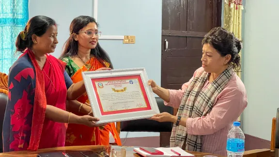 LWF Nepal Country Representative Dr. Bijaya Bajracharya (right) receives an appreciation letter from the leaders of the local government. The letter was issued by the local government and appreciates the collaboration with LWF and its local partner organization SNJD in Jhapa district. Photo: LWF/ Y. Gautam