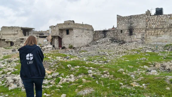 Khamees in front of a building in Aleppo. Photo: LWF Jordan