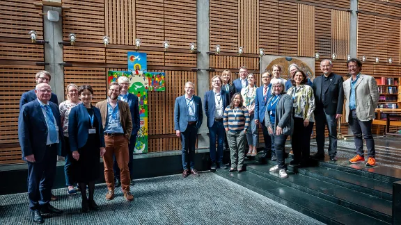 Participants and LWF leadership gather around the Lund cross in the Ecumenical Center chapel. Photo: LWF/ S. Gallay