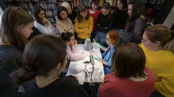 Participants witness a demonstration at the manicure workshop. Photo: LWF/ Albin Hillert