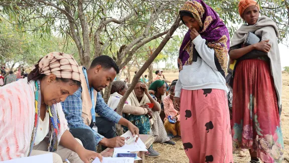 An LWF cash distribution in Tigray. The payments are being checked with ID cards, and signed for with finger prints. Photo:LWF/ Daniel ZeMichael