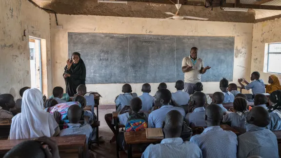 Class is underway at Shabele Primary School, taught by teacher Rogers Juma (right) and with sign-language interpretation given by Learning Support Assistant Amiza Lumumba (left). Photo: LWF/ Albin Hillert