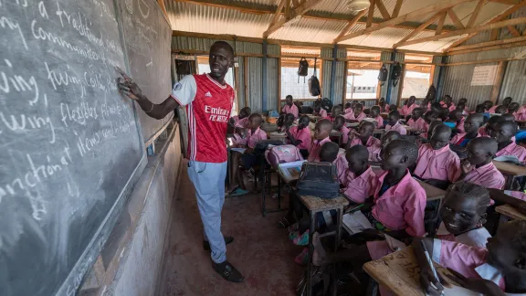 Teacher James Lobalu, teaches a class of fourth-graders at Peace Primary School. Photo: LWF/ Albin Hillert