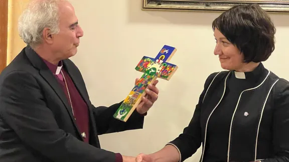 LWF General Secretary Rev Dr Anne Burghardt presents a replica of the Lund cross from El Salvador to Bishop Sani Ibrahim Azar. Photo; LWF/ Maddi Froiland