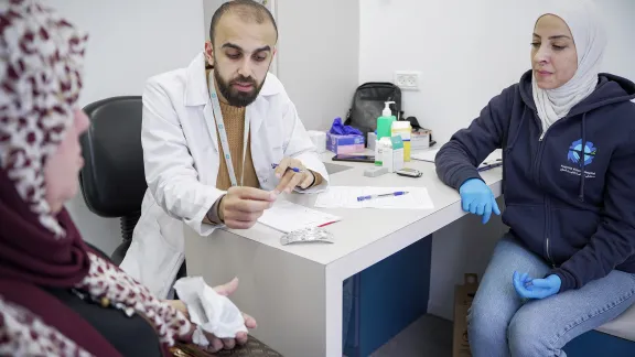 Dr Maen Hay Ahmed (center) and nurse Reena Abu Sneineh (right) during consultation in the mobile diabetes unit. Photo: LWF/ Abdalla Elayyan