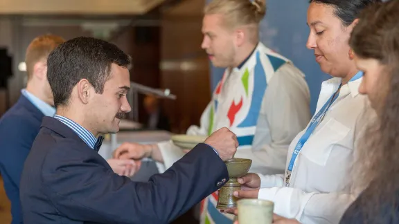 Distribution of Holy Communion at the opening service of the 2024 LWF Council meeting. The Eucharist wafers were a gift from the Evangelical Lutheran Church in Tanzania. Photo: LWF/Albin Hillert