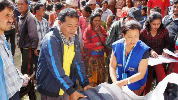 LWF staff distribute blankets and tarpaulins in the Kathmandu valley, after the 2015 earthquake. Photo: LWF/ C. Kästner-Meyer