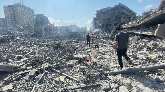 Palestinians walk among the rubble caused by an Israeli airstrike on Gaza City. Photo: Wafa / APAImages (CC-BY-SA)