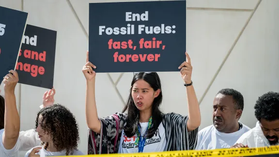 Participants in the COP28 climate summit in Dubai, United Arab Emirates last December, highlight the urgency of ending the use of fossil fuels. Photo: LWF/A. Hillert