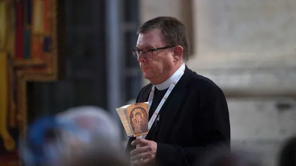 Prof. Dirk Lange holds a candle during the 11 October Ecumenical Vigil with Synod participants. Photo: CatholicPressPhoto/A. Giuliani