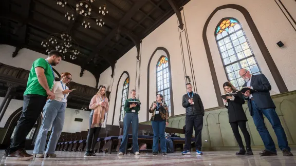 LWF delegates to COP29 gather for a moment of prayer at the Evangelical Lutheran Church in Georgia, Baku congregation. Photo: LWF/Albin Hillert