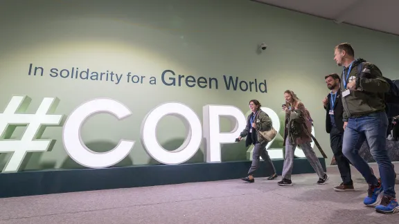 LWF delegates to COP29 walk through the venue in Baku, Azerbaijan. Photo: LWF/Albin Hillert