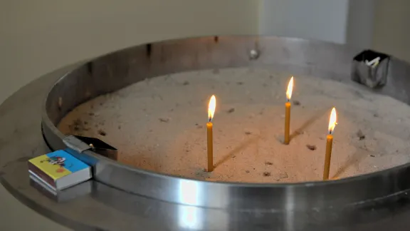 Prayer candles burn during Sunday service in the Lutheran church St. Catherine in Kyiv, 12 May 2024. Photo: LWF/ Cornelia Kästner-Meyer