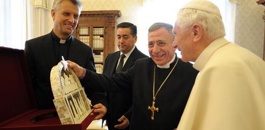 December 2010: LWF General Secretary Rev. Martin Junge (left) and LWF President Bishop Dr Munib A. Younan (middle) present Pope Benedict XVI with a gift from Bethlehem depicting the Last Supper. Â© Servizio Fotografico 