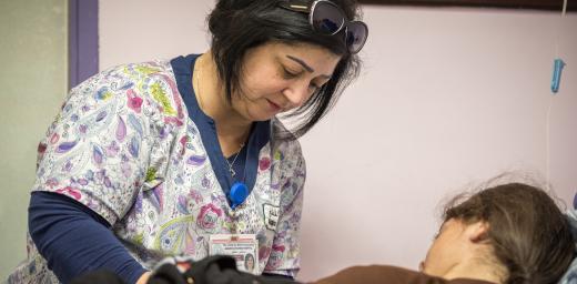 Rihab George, senior nurse in the outpatient unit of the Augusta Victoria Hospital, disconnects a bag of antibiotics from a child patient. The hospital offers specialized treatment to Palestinians which is not available to them elsewhere. Photo: LWF/Albin Hillert