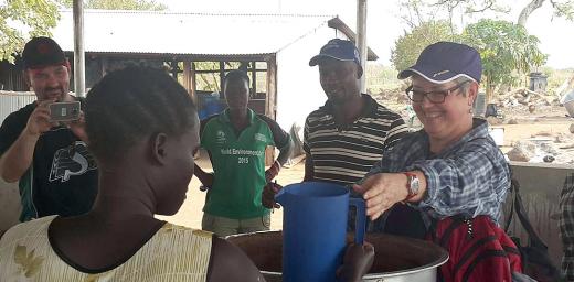 Bishop Susan Johnson handing out relief goods to refugees in Nyumanzi reception center. Photo: LWF Uganda