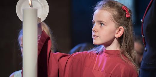 A girl lights a candle at Lund Cathedral, signifying one of the five ecumenical imperatives. Photo: LWF/Albin Hillert