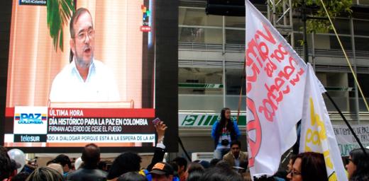 People in Colombia watch the news announcing the peace agreement. Photo: Diego Loaiza