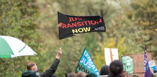 âJust transition nowâ reads a flag waving in the wind. Thousands of people joined a march through Glasgow city center, calling for climate justice and world leaders to address the climate emergency at COP26. Photo: LWF/Albin Hillert