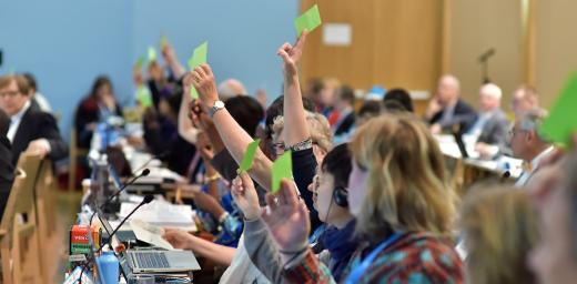 Holding the green card: members of the LWF Council vote on a proposal at the 2016 Council meeting. Photo: LWF/M. Renaux