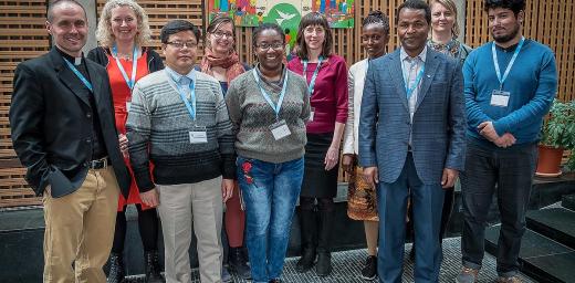 Members of the LWF Theological Education and Formation advisory group stand before the Lund Cross in the chapel of the Ecumenical Centre in Geneva. Photo: LWF/S. Gallay