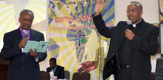 Rev. Yonas Yigezu, right, pledges to lead the Ethiopian Evangelical Church Mekane Yesus with unity and love. On left, outgoing EECMY president, Rev. Dr Wakseyoum Idosa. Photo: EECMY/Tsion Alemayehu