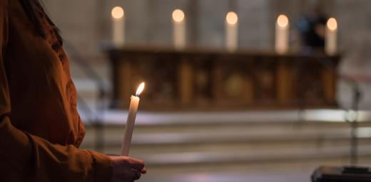 16 June 2019, Geneva, Switzerland: Gathered in Saint Peter's Cathedral in central Geneva, Emma van Dorp, a theology student from the Reformed congregation, lights five symbolic candles on the altar as the church leaders affirm the 'wish to make more visible our common witness in worship and service, on our journey together towards visible unity.' Photo: LWF/Albin Hillert