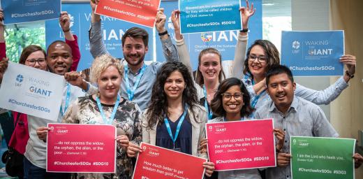 LWF Council youth delegates hold posters at the launch of the Waking the Giant ecumenical initiative in Geneva. Photo: LWF/S. Gallay