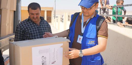 LWF assisting in the distribution of winter clothes sponsored by the Evangelical Lutheran Church of Bavaria in Khanki camp, Northern Iraq. Photo: LWF Iraq