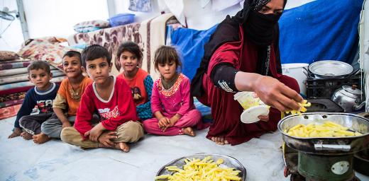 A mother prepares a meal for her children. The family fled from Mosul a few weeks ago and now lives in Debaga camp. All images: LWF/ Seivan Salim
