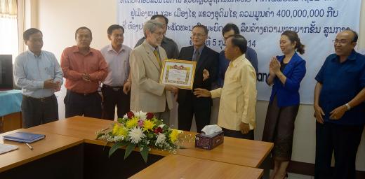 Mr David Mueller, LWF regional representative for Southeast Asia, receives the Laos' government award. Photo: LWF/DWS Laos/Alounsavanh Xaysonkham