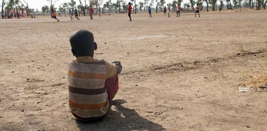 A little boy watches a football game in a child friendly space, Gendrassa refugee camp, South Sudan. Photo: LWF/ C. KÃ¤stner