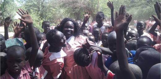 Margaret Awak Aguer is mobbed and lifted by fellow students at Shambe Primary School after emerging as the best candidate in Kakuma Refugee camp in the 2015 KCPE with 400 out of a possible 500 marks Â© LWF Kakuma January 2016