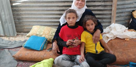 Salam (left, in red T-Shirt) with her grandmother and younger sister in their shelter in Zaâatari camp. Photo: LWF Jordan/D. OdÃ©n