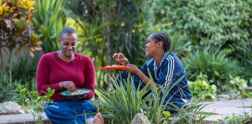 Two friends enjoy a meal on the campus of the ELCT-Diocese of Meru, Usa River Rehabilitation and Training Centre for people with special needs, in Arusha, Tanzania. All photos: LWF/Albin HillertÂ 