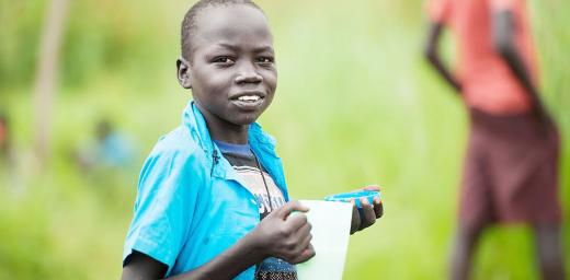 A young South Sudanese refugee eats porridge in Northern Uganda. Photos:LWF/Uganda