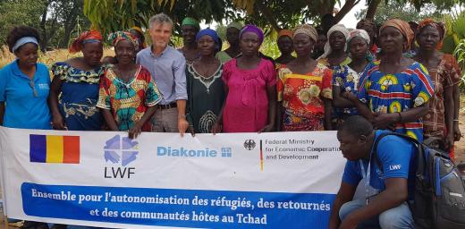 LWFâs Josef Pfattner stands with a group working on strengthening resilience and self-sufficiency for women in Chad. Photo: LWF/Chad