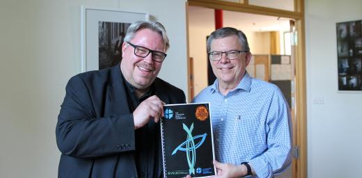Dr. Uwe Steinmetz, who led the project since 2019, and Prof. Dr Dirk Lange, LWF Assistant General Secretary for Ecumenical Relations, showing the new Global Songbook 2024. Photo: LWF/A. Weyermüller