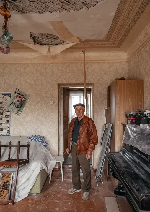 A man in his apartment, which was partly destroyed by rocket explosions. The LWF team met the families and inspected the apartments to be included in the first phase of LWF’s shelter rehabilitation project in Kharkiv. Photo: LWF/ Anantoliy Nazarenko